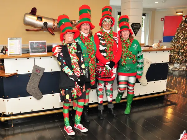 Friends in striped elf hats and holiday sweaters