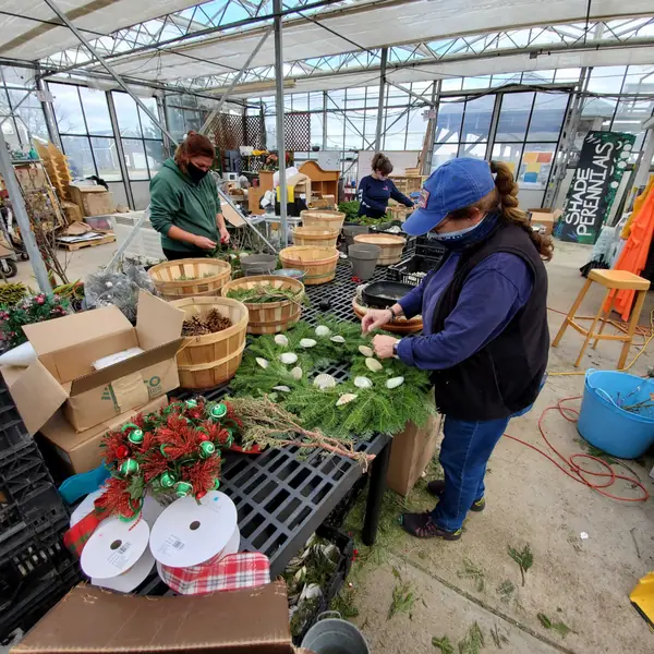 Volunteers making seashell holiday wreaths
